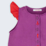 Camisa infantil menina em linho roxo com mangas de babado vermelho e bordado de bichinhos do fundo do mar entre os botões, vista de frente em detalhe.