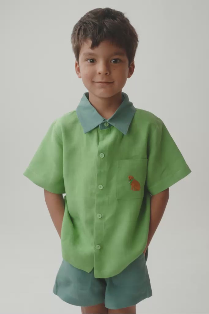 Criança em movimento usando camisa Tom caramelo, mostrando o caimento da peça e os detalhes feitos à mão.