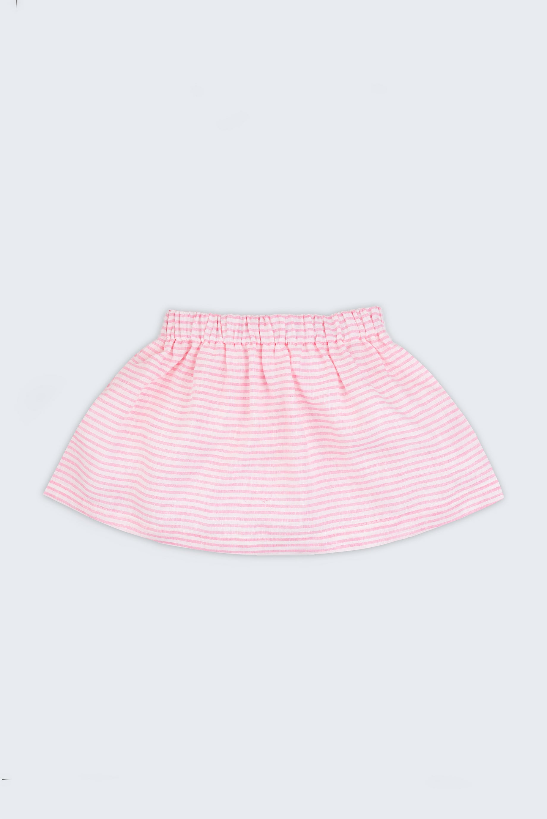 Saia infantil em linho listrado rosa e branco com elástico na cintura para meninas, vista de frente sobre fundo neutro.