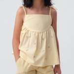 Menina vestindo Shorts Chico infantil xadrez amarelo em algodão, combinado com bata no mesmo tecido.