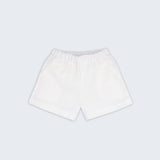 Shorts infantil em linho puro branco com bolsos frontais e cintura elástica para meninos e meninas, visto de frente.