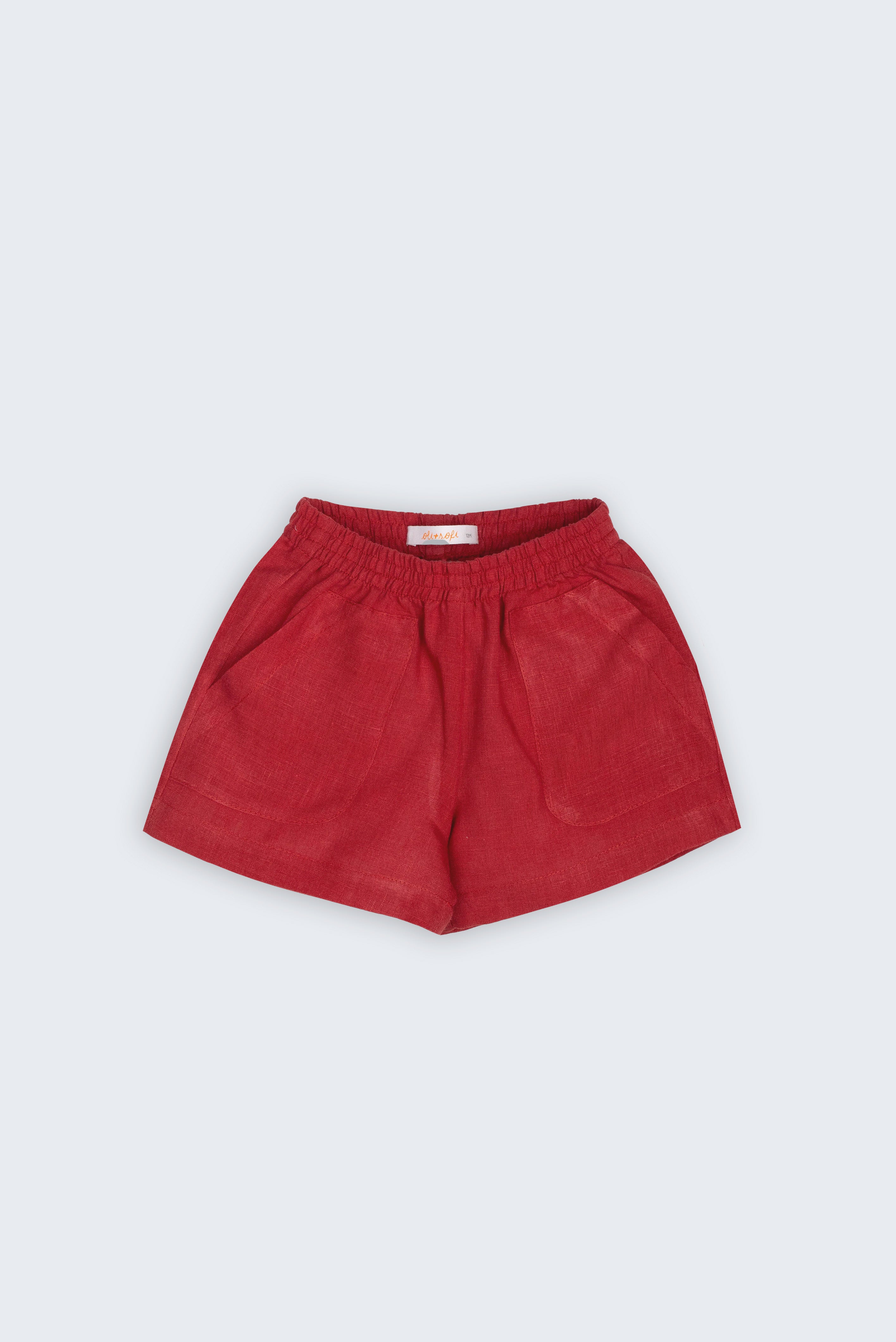 Shorts Chico infantil em linho vinho fotografado de frente, com cintura de elástico e bolsos frontais, modelo para menino e menina.