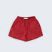Shorts Chico infantil em linho vinho fotografado de frente, com cintura de elástico e bolsos frontais, modelo para menino e menina.